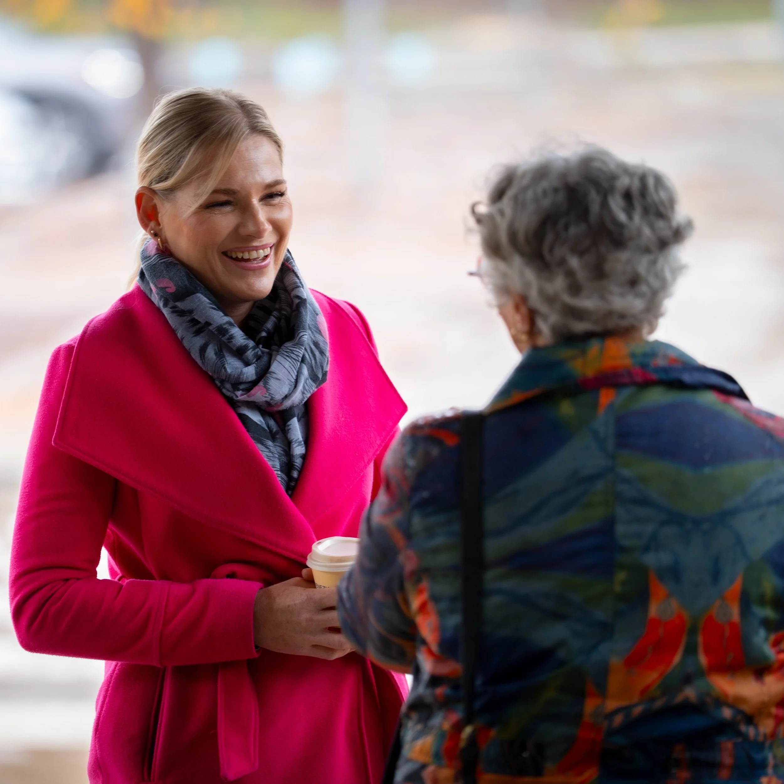 Leanne Castley speaking with a community member